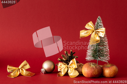 Image of Christmas decoration with a fir tree on red background