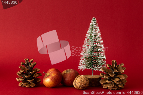 Image of Christmas decoration with a fir tree on red background