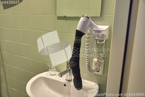 Image of Drying sock in a hairdryer