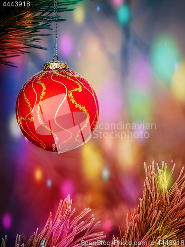Image of Christmas ball on the fir branch. Place for inscription.