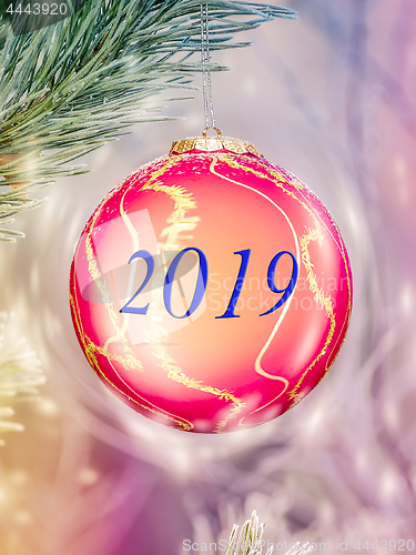 Image of Big Christmas ball on the fir branch. Place for inscription.