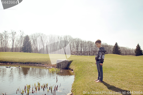 Image of Boy in the park by the lake