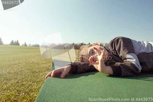 Image of Boy sleep outdoors in the autumn park