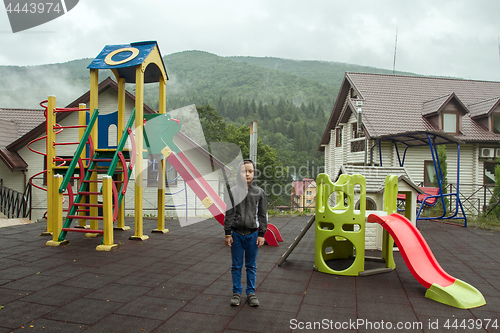 Image of Boy on the playground near the mountains