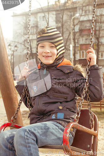 Image of Boy swinging on a swing