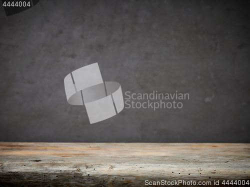 Image of wooden table and grey wall