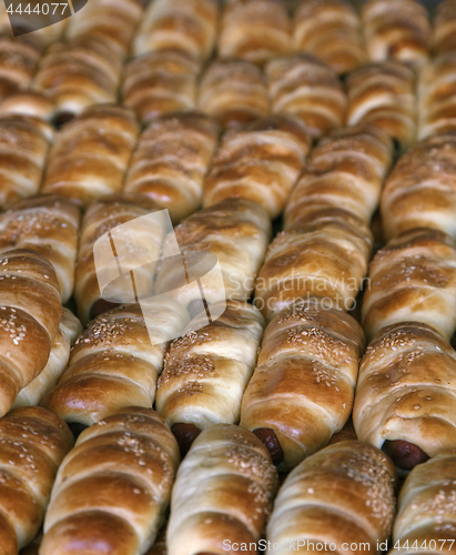 Image of Sausages baked in dough on the tray