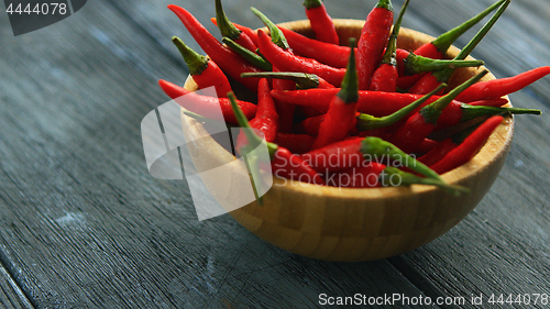 Image of Wooden bowl full of chili pepper