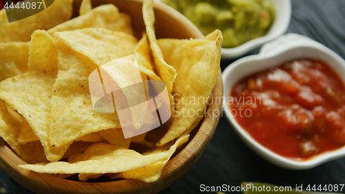 Image of Nachos served with dip sauces 