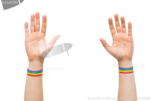 Image of hands with gay pride rainbow wristbands