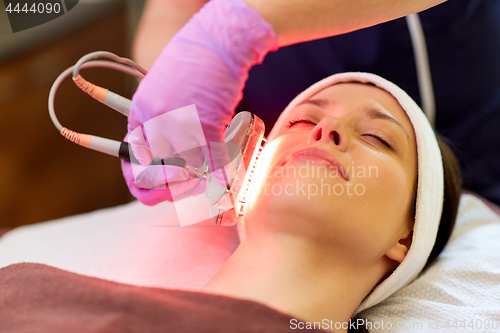 Image of young woman having face microdermabrasion at spa