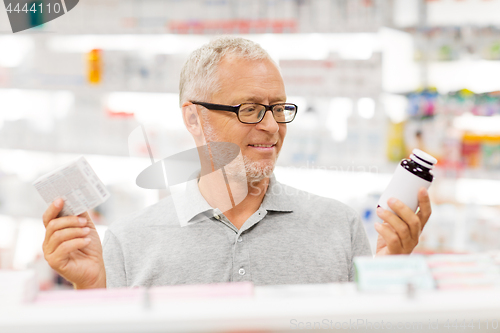 Image of senior male customer choosing drugs at pharmacy