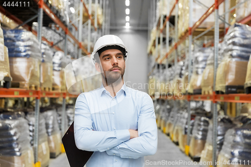 Image of businessman in helmet at warehouse