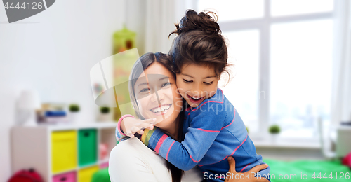 Image of happy mother and daughter hugging at home