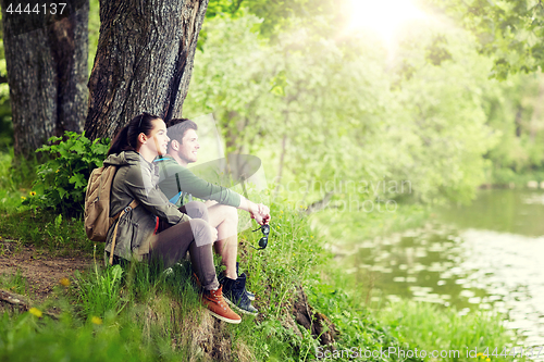 Image of smiling couple with backpacks in nature