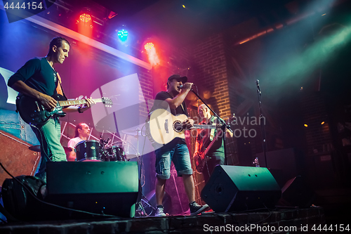 Image of Band performs on stage in a nightclub