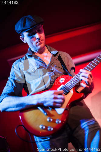 Image of Band performs on stage in a nightclub