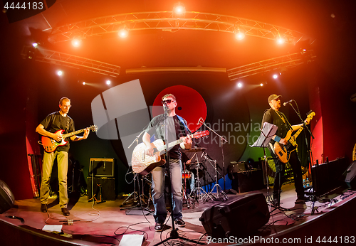 Image of Band performs on stage in a nightclub