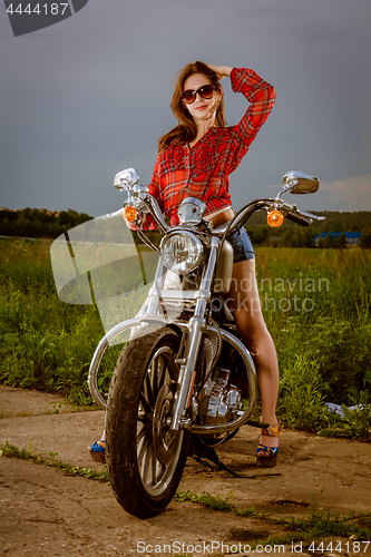 Image of Biker girl and motorcycle