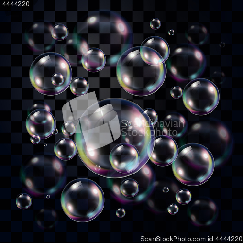 Image of Transparent and multicolored soap bubbles over dark 