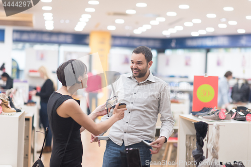 Image of couple chooses shoes At Shoe Store