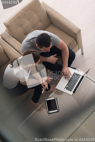 Image of happy young couple buying online