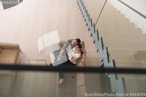 Image of couple relaxing at  home with tablet computers