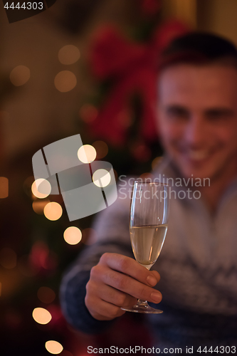 Image of Happy young man with a glass of champagne