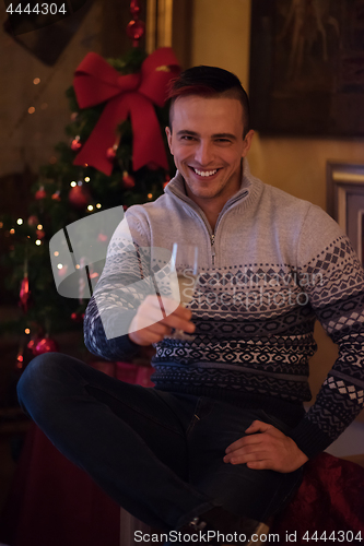 Image of Happy young man with a glass of champagne