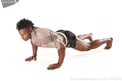 Image of Muscular young man doing press-ups