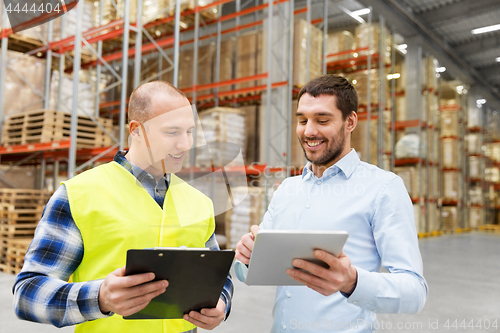 Image of worker and businessman with tablet pc at warehouse