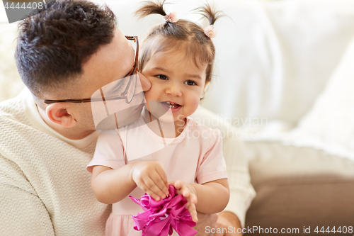 Image of close up of father kissing little daughter