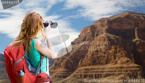 Image of woman with backpack and camera at grand canyon