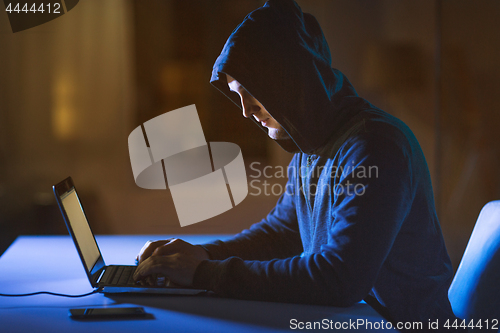 Image of hacker using laptop computer for cyber attack