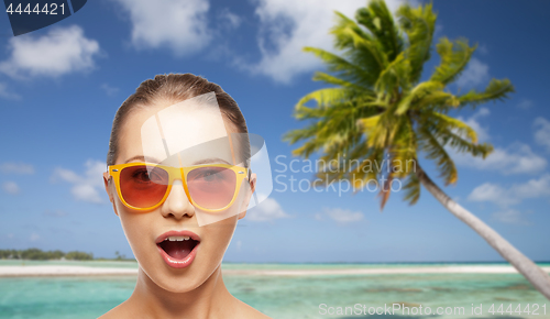 Image of happy woman or teenage girl in sunglasses on beach