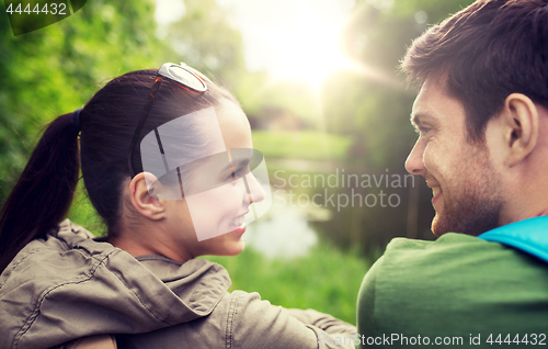 Image of smiling couple with backpacks in nature