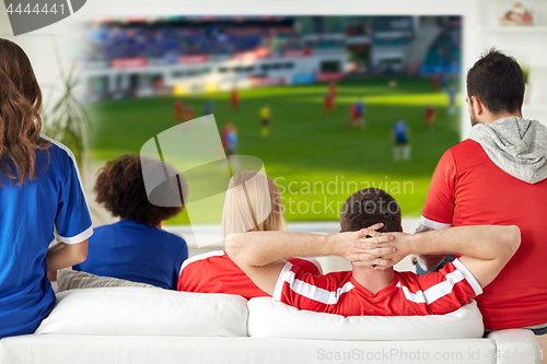 Image of friends or football fans watching soccer at home