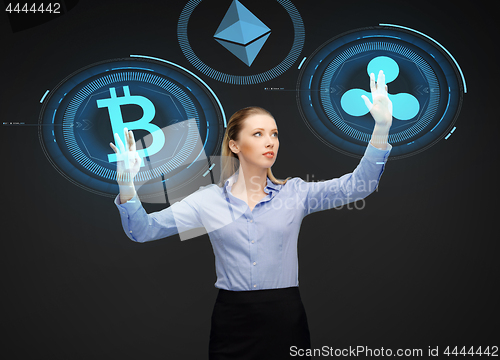 Image of businesswoman with cryptocurrency holograms