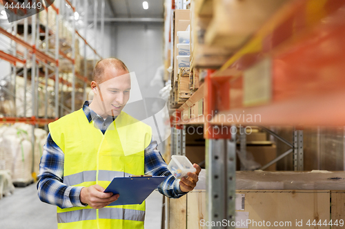 Image of warehouse worker with clipboard and plastic box