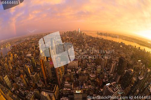 Image of New York City skyline with Manhattan skyscrapers at dramatic stormy sunset, USA.