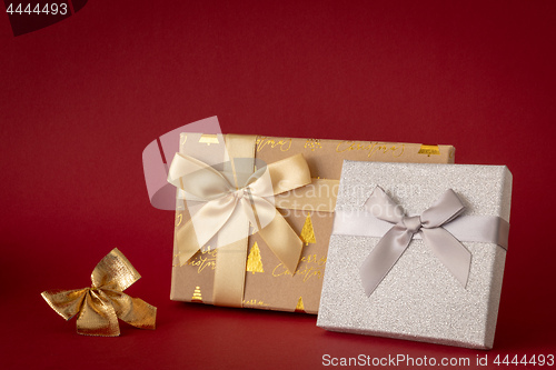 Image of Christmas decoration with two gift boxes on red background