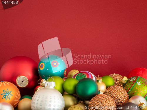 Image of Christmas decoration glass balls on red background