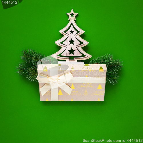 Image of Christmas decoration green background with fir tree and gift box