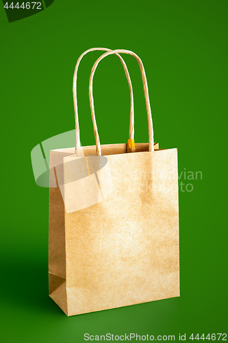 Image of beige paper bag isolated on green background