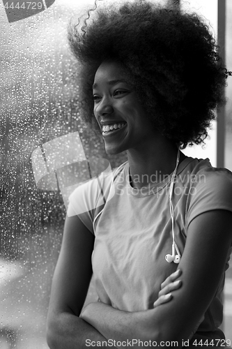 Image of portrait of young afro american woman in gym while listening mus