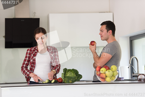 Image of Young handsome couple in the kitchen