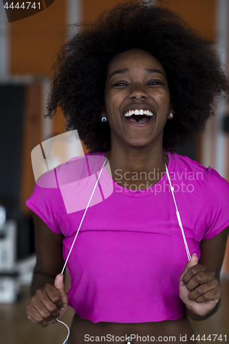 Image of afro american woman running on a treadmill