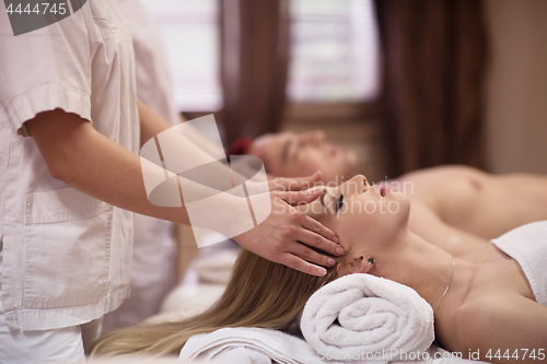 Image of couple enjoying head massage at the spa