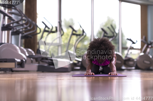 Image of african american woman exercise yoga in gym