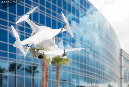 Image of Unmanned Aircraft System (UAS) Quadcopter Drone In The Air Near 